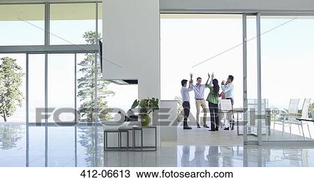 Business people cheering in office View Large Photo Image Stock Image - Business people cheering in office. Fotosearch
