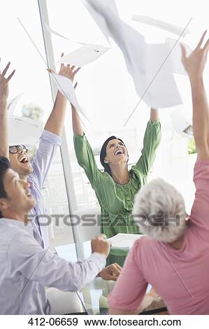 Business people cheering in office View Large Photo Image Stock Photo - Business people cheering in office. Fotosearch