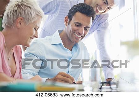 Stock Image - Business people signing contract in office. Fotosearch