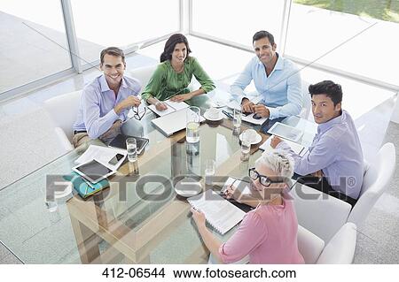 Business people smiling in meeting View Large Photo Image Picture - Business people smiling in meeting. Fotosearch