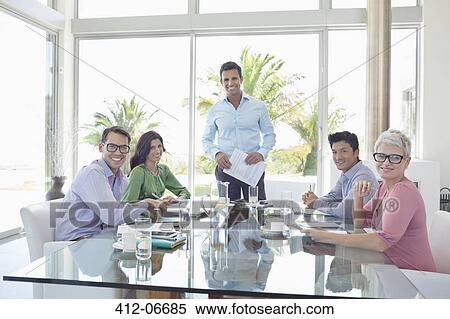 Business people smiling in meeting View Large Photo Image Stock Photography - Business people smiling in meeting. Fotosearch