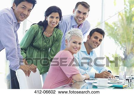Business people smiling in office View Large Photo Image Stock Image - Business people smiling in office. Fotosearch