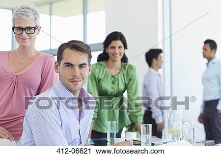 Business people smiling in office View Large Photo Image Stock Image - Business people smiling in office. Fotosearch