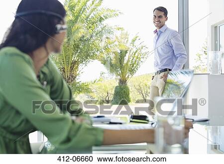Business people smiling in office View Large Photo Image Stock Image - Business people smiling in office. Fotosearch