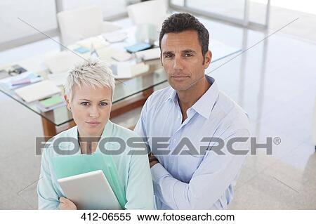 Stock Photography - Business people standing together in office. Fotosearch
