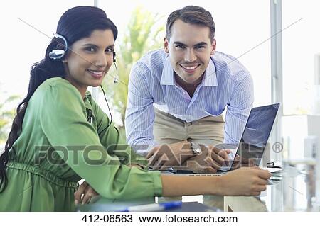 Business people talking at desk View Large Photo Image Stock Image - Business people talking at desk. Fotosearch