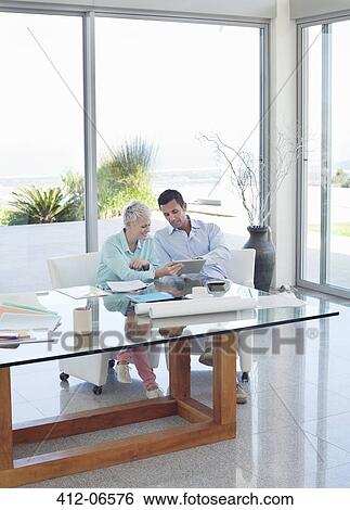 Business people talking at desk View Large Photo Image Stock Photograph - Business people talking at desk. Fotosearch
