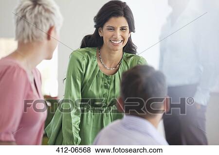 Business people talking in office View Large Photo Image Stock Photo - Business people talking in office. Fotosearch