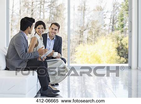 Business people talking on sofa in office View Large Photo Image Stock Photography - Business people talking on sofa in office. Fotosearch