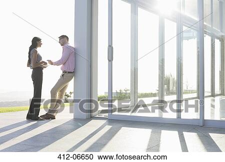 Stock Image - Business people talking outside office. Fotosearch