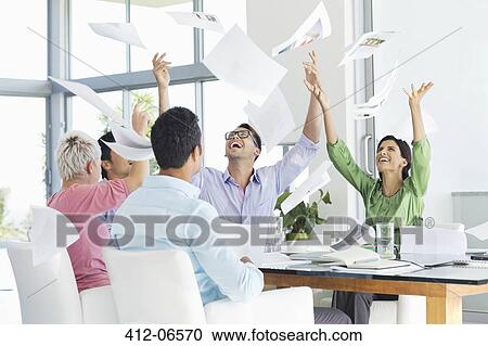 Business people tossing papers in air in meeting View Large Photo Image Stock Image - Business people tossing papers in air in meeting. Fotosearch