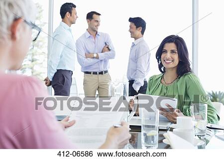 Business women talking in meeting View Large Photo Image Stock Photograph - Business women talking in meeting. Fotosearch