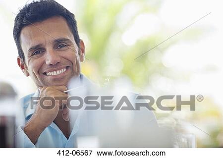 Businessman smiling at desk View Large Photo Image Stock Photo - Businessman smiling at desk. Fotosearch