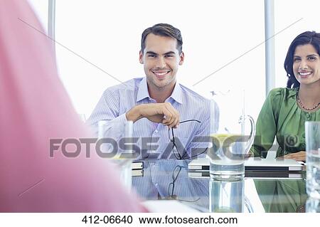 Businessman smiling in meeting View Large Photo Image Stock Image - Businessman smiling in meeting. Fotosearch