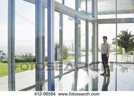 Picture - Businessman standing in office. Fotosearch