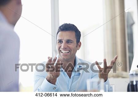 Picture - Businessman talking in meeting. Fotosearch