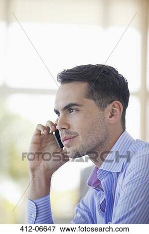 Stock Photo - Businessman talking on cell phone. Fotosearch
