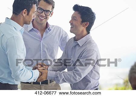 Businessmen shaking hands in office View Large Photo Image Stock Photo - Businessmen shaking hands in office. Fotosearch
