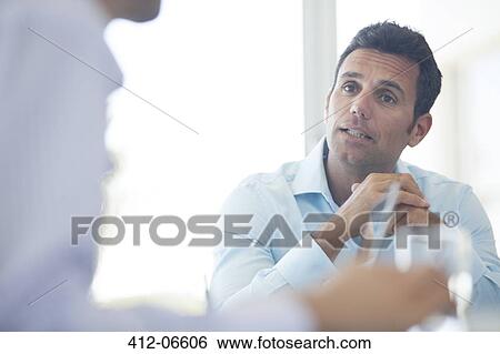 Stock Photograph - Businessmen talking in meeting. Fotosearch