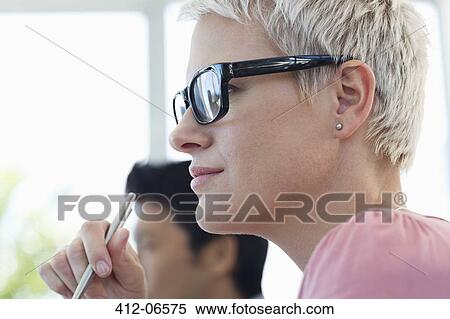 Stock Photography - Businesswoman sitting in meeting. Fotosearch