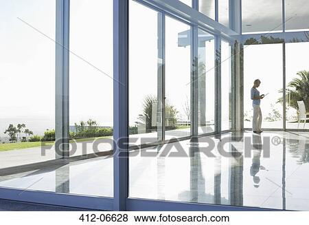 Businesswoman using tablet computer in office View Large Photo Image Stock Photo - Businesswoman using tablet computer in office. Fotosearch