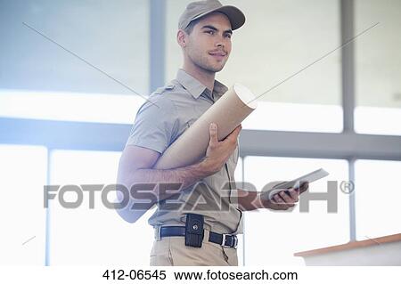 Delivery boy carrying package View Large Photo Image Stock Photography - Delivery boy carrying package. Fotosearch