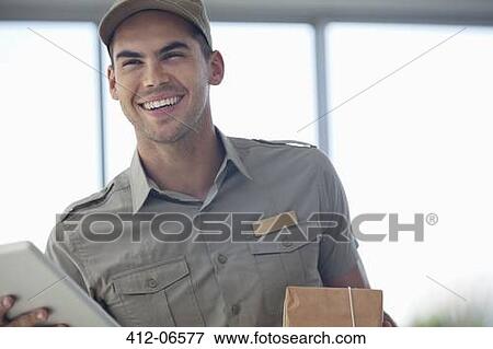 Delivery boy smiling with package View Large Photo Image Stock Photo - Delivery boy smiling with package. Fotosearch