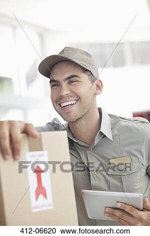 Delivery boy using tablet computer View Large Photo Image Stock Image - Delivery boy using tablet computer. Fotosearch