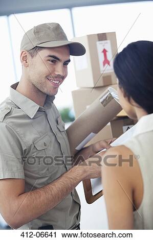 Delivery boy with packages for businesswoman View Large Photo Image Stock Image - Delivery boy with packages for businesswoman. Fotosearch