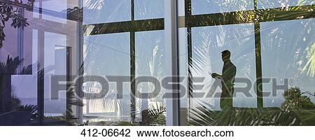 Reflection of businessman in window View Large Photo Image Stock Image - Reflection of businessman in window. Fotosearch