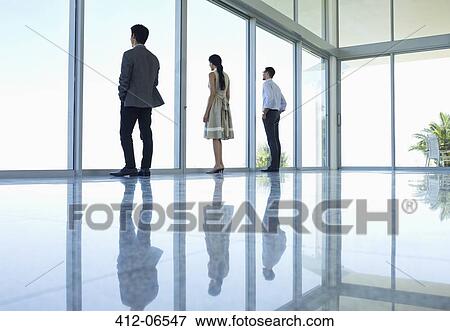 Stock Photo - Reflections of business people in office floor. Fotosearch