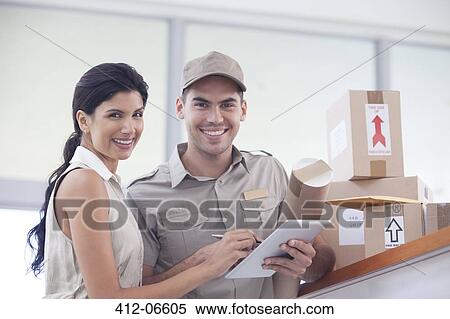 Woman signing for packages from delivery boy View Large Photo Image Stock Photography - Woman signing for packages from delivery boy. Fotosearch