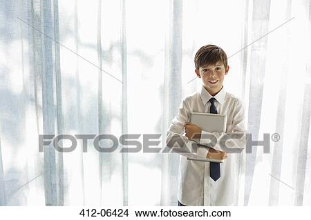 Boy in shirt and tie holding tablet computer View Large Photo Image Picture - Boy in shirt and tie holding tablet computer. Fotosearch