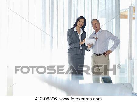 Business people smiling in office View Large Photo Image Stock Photograph - Business people smiling in office. Fotosearch