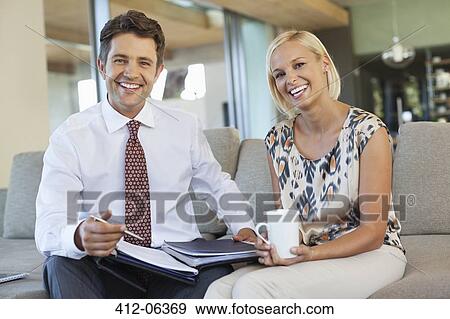 Business people talking on sofa View Large Photo Image Stock Photo - Business people talking on sofa. Fotosearch