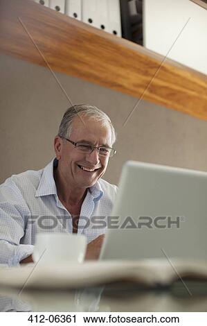 Businessman working at desk View Large Photo Image Stock Image - Businessman working at desk. Fotosearch