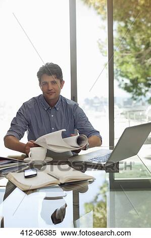Stock Photography - Businessman working at desk. Fotosearch