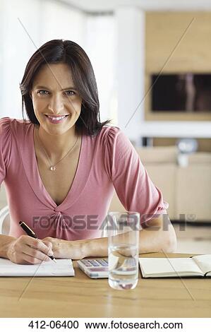 Businesswoman working at desk View Large Photo Image Stock Image - Businesswoman working at desk. Fotosearch