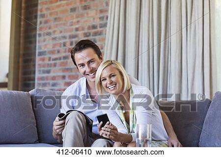 Couple relaxing on sofa together View Large Photo Image Stock Image - Couple relaxing on sofa together. Fotosearch