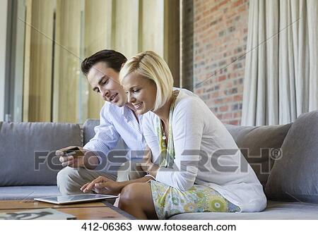 Stock Image - Couple shopping online with tablet computer. Fotosearch