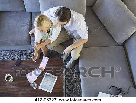 Couple using tablet computer on sofa View Large Photo Image Stock Photo - Couple using tablet computer on sofa. Fotosearch