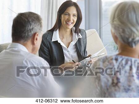 Stock Image - Financial advisor talking to clients in office. Fotosearch