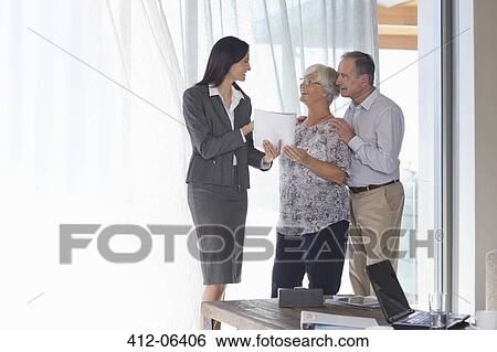 Financial advisor talking to couple in office View Large Photo Image Stock Photograph - Financial advisor talking to couple in office. Fotosearch