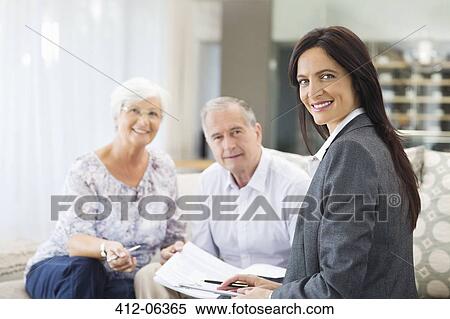 Financial advisor talking to couple on sofa View Large Photo Image Stock Photography - Financial advisor talking to couple on sofa. Fotosearch