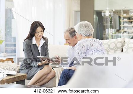 Financial advisor using tablet computer with clients View Large Photo Image Stock Image - Financial advisor using tablet computer with clients. Fotosearch