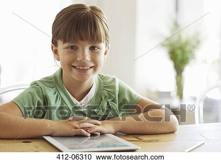 Stock Image - Girl smiling with tablet computer. Fotosearch