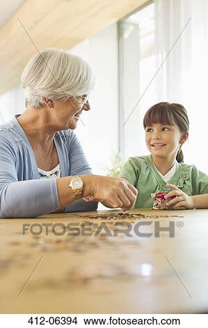 Older woman and granddaughter counting pennies View Large Photo Image Picture - Older woman and granddaughter counting pennies. Fotosearch