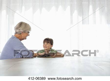 Stock Photo - Older woman and granddaughter using tablet computer. Fotosearch