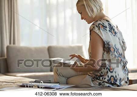 Woman using tablet computer on sofa View Large Photo Image Stock Photo - Woman using tablet computer on sofa. Fotosearch