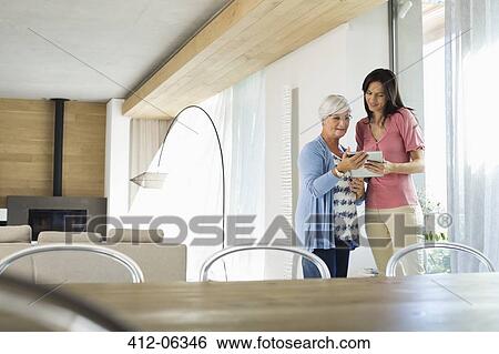 Women using tablet computer together View Large Photo Image Stock Photograph - Women using tablet computer together. Fotosearch